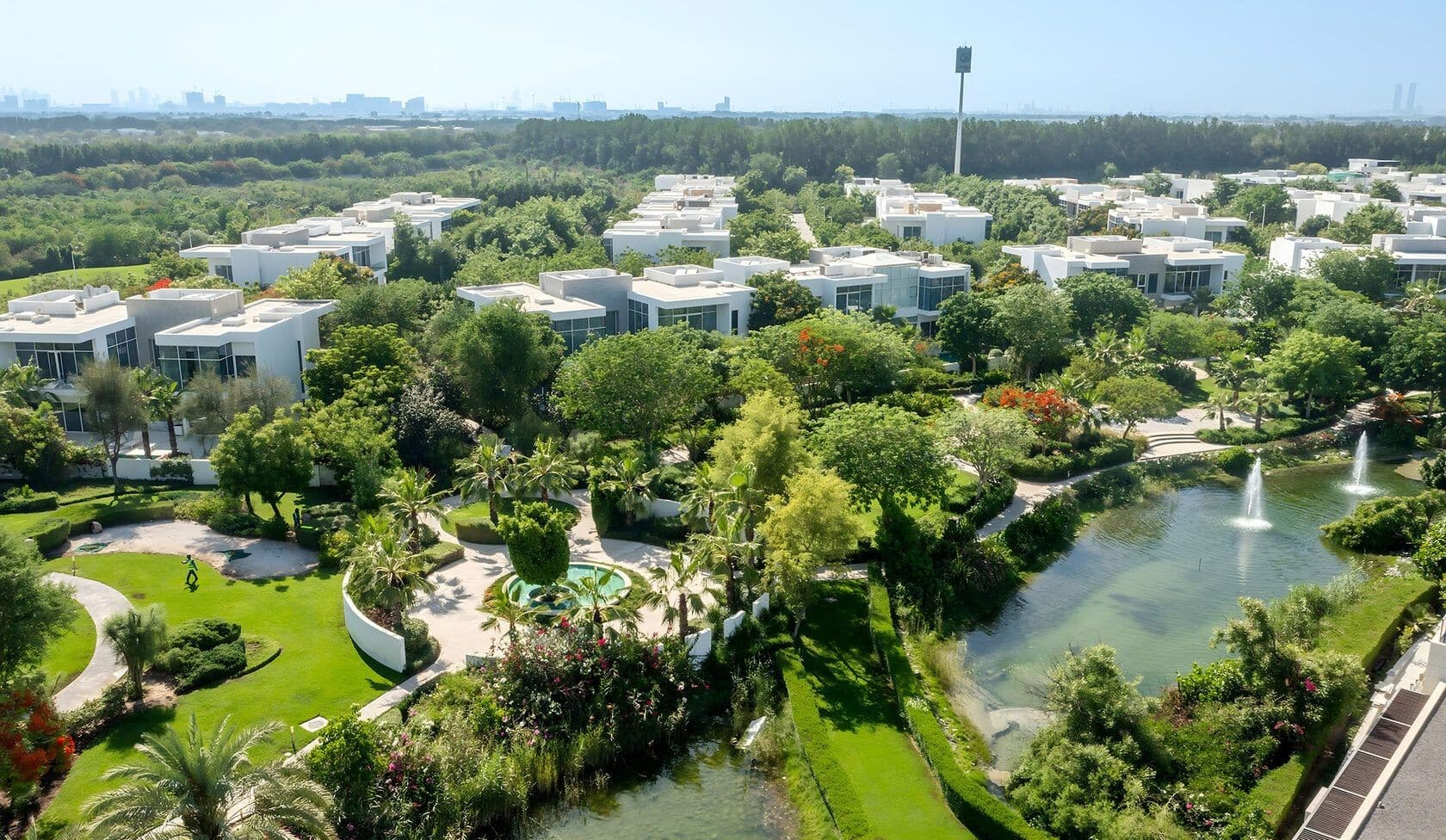Aerial view of Al Barari villas among gardens, waterways and dense greenery
