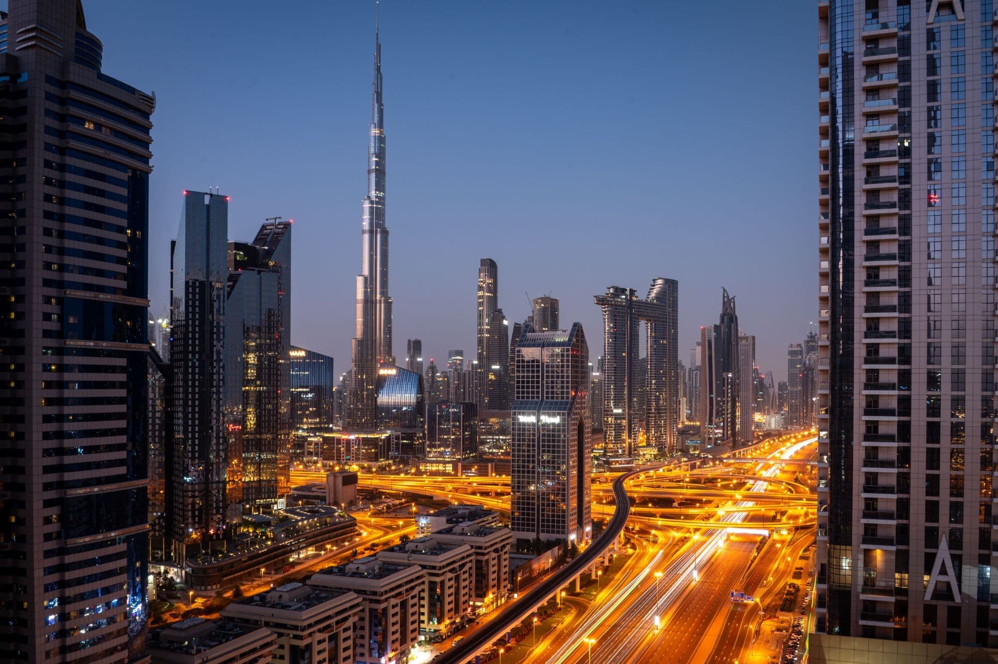 Downtown Dubai at blue hour with Burj Khalifa above the Sheikh Zayed Road interchange