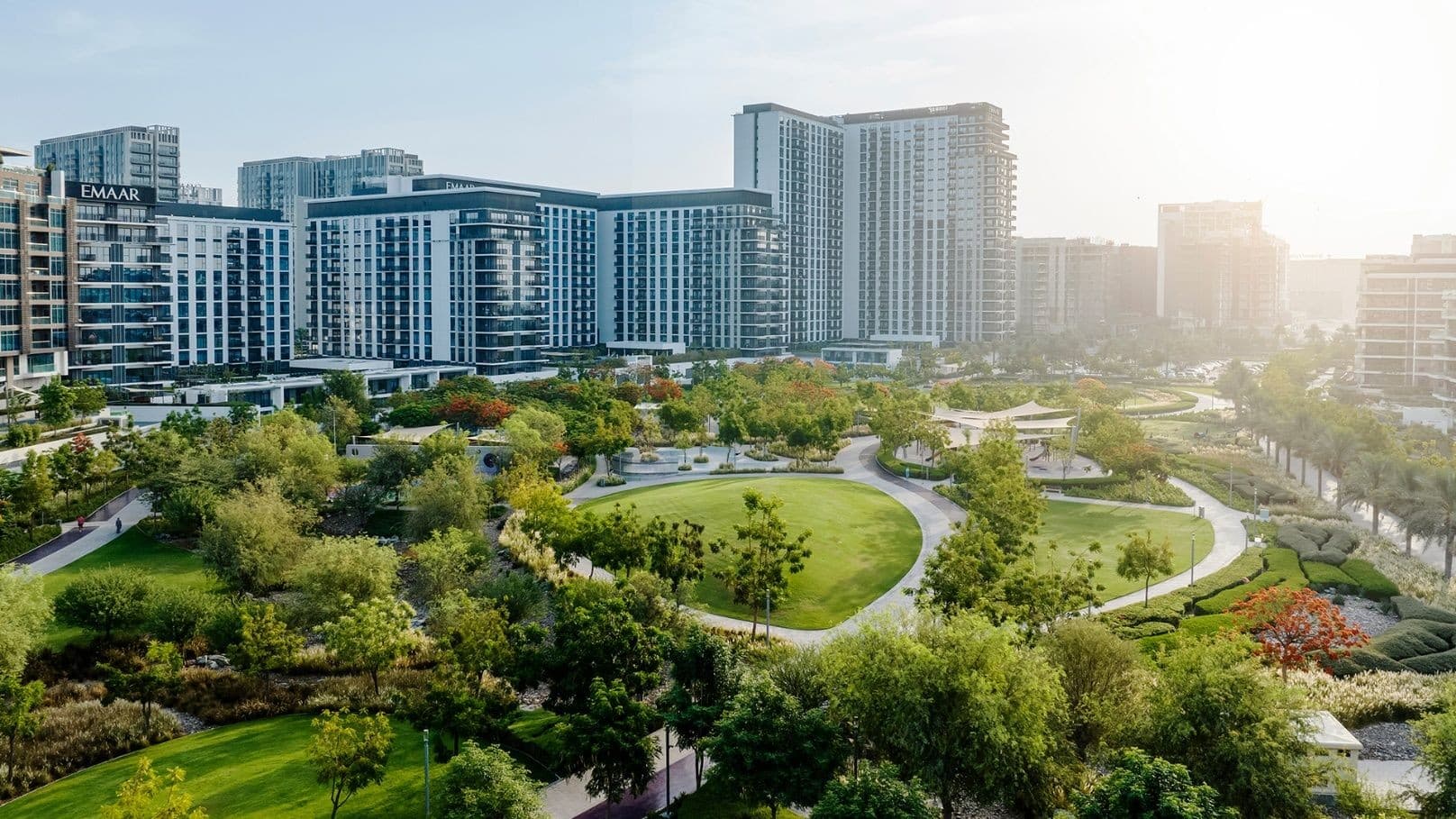 Dubai Hills Park with the Emaar apartment blocks of Dubai Hills Estate behind