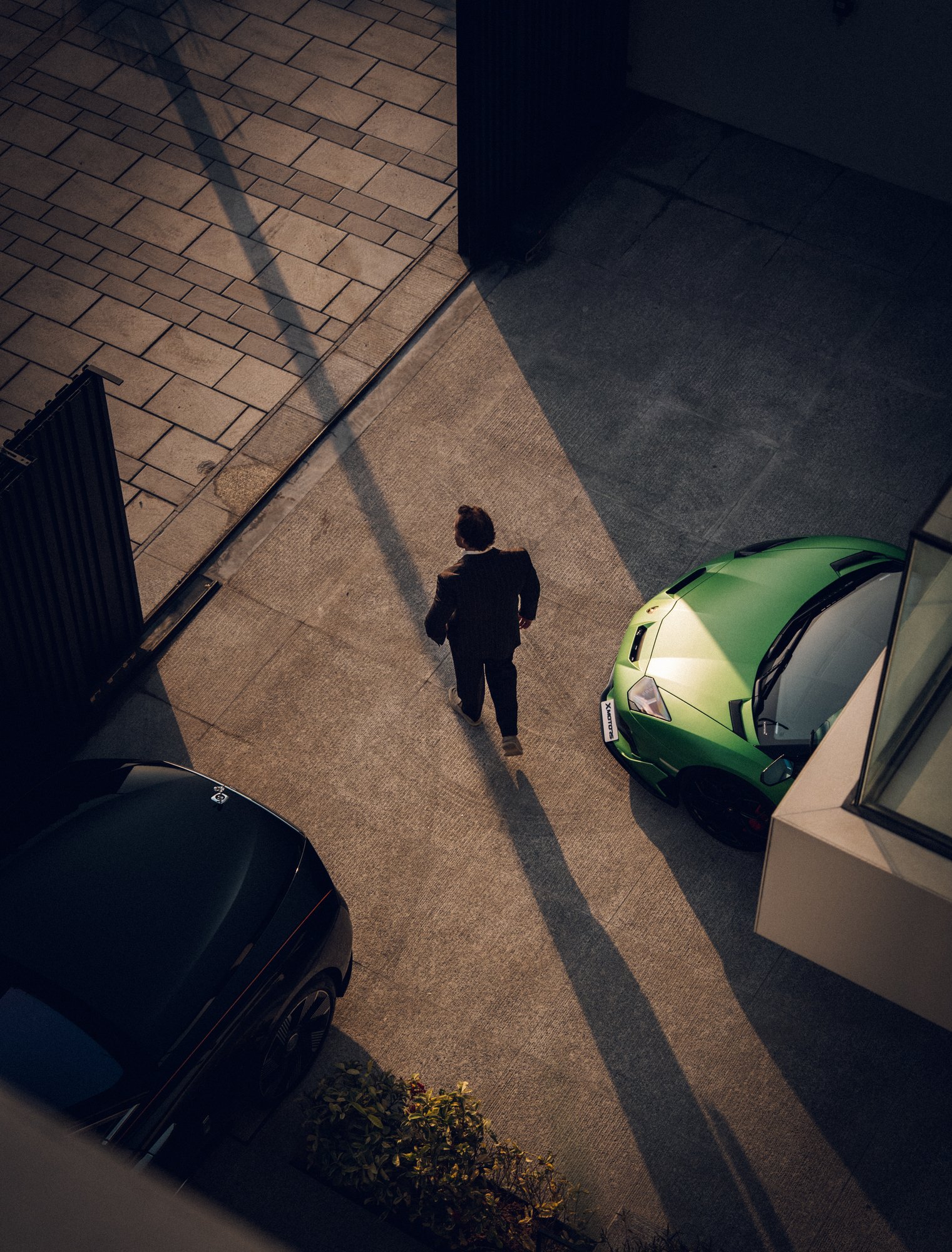 Evening light over a villa driveway with a green Lamborghini