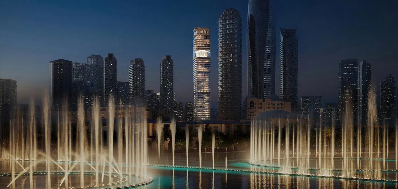 Inaura tower with illuminated crown seen across the Dubai Fountain