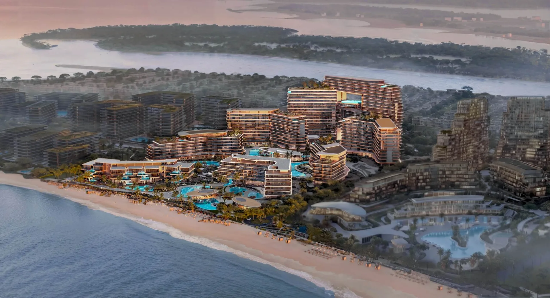Sunset aerial of the beachfront cluster on the island