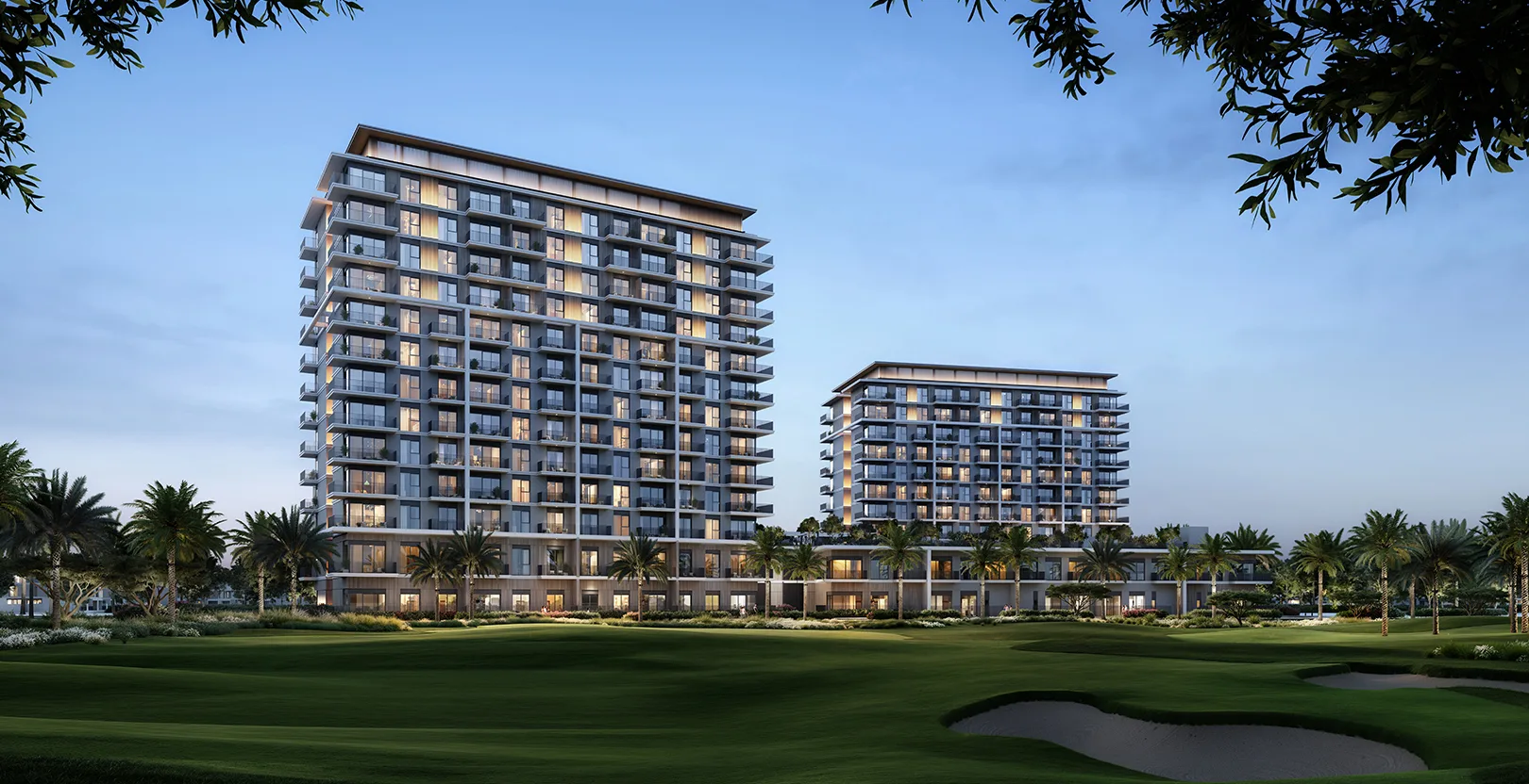 Two golf-front towers at dusk over the fairway